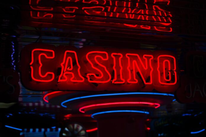Photo by Ben Lambert red Casino neon sign turned on