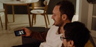 What Is StarzMirror? two sitting men watching from smartphone
