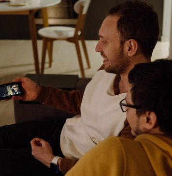 What Is StarzMirror? two sitting men watching from smartphone
