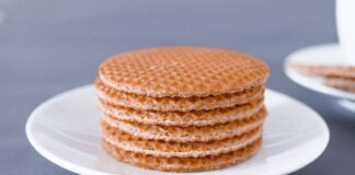 These three Dutch biscuits are incredibly delicious brown round cookies on white ceramic plate
