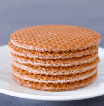 These three Dutch biscuits are incredibly delicious brown round cookies on white ceramic plate