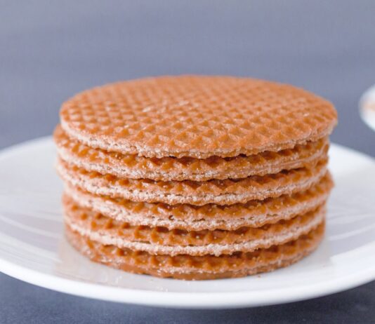 These three Dutch biscuits are incredibly delicious brown round cookies on white ceramic plate