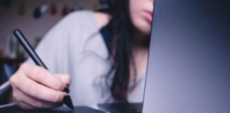 Should You Automate Your Lending Process? A Bit by Byte Overview woman using drawing pad while sitting in front of laptop