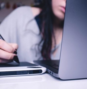 Should You Automate Your Lending Process? A Bit by Byte Overview woman using drawing pad while sitting in front of laptop