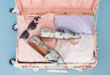 5 Summer Essentials You Need in Your Wardrobe clothing items and pair of shoes in luggage