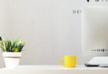 How to Set Up a Home Office for Remote Work yellow ceramic mug beside gray aluminum iMac