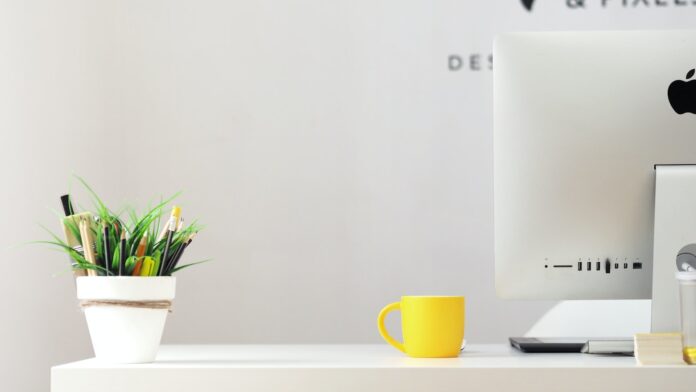 Photo by Georgie Cobbs yellow ceramic mug beside gray aluminum iMac