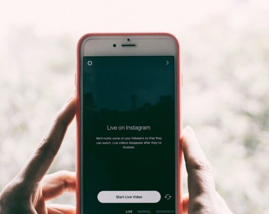 How Instagram Can Help Grow Your Business person holding iPhone