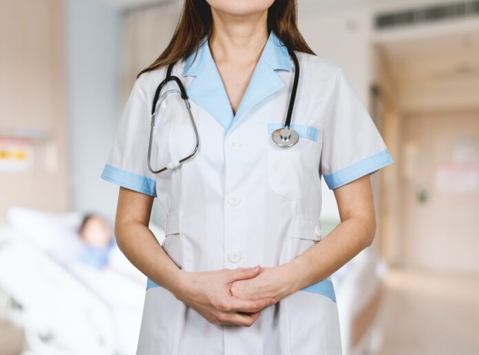 Photo by JESHOOTS.COM woman in white button up shirt and blue stethoscope