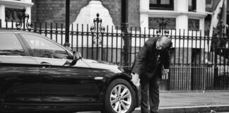 Is It Possible To Get a Short Term Car Insurance? man holding vehicle tire