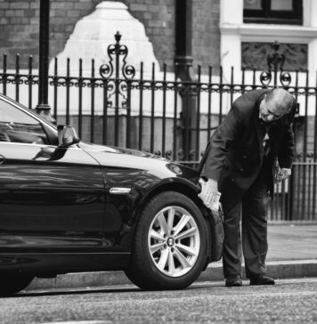 Is It Possible To Get a Short Term Car Insurance? man holding vehicle tire