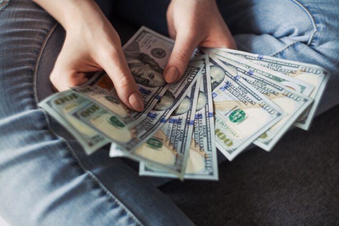 Photo by Alexander Mils fan of 100 U.S. dollar banknotes