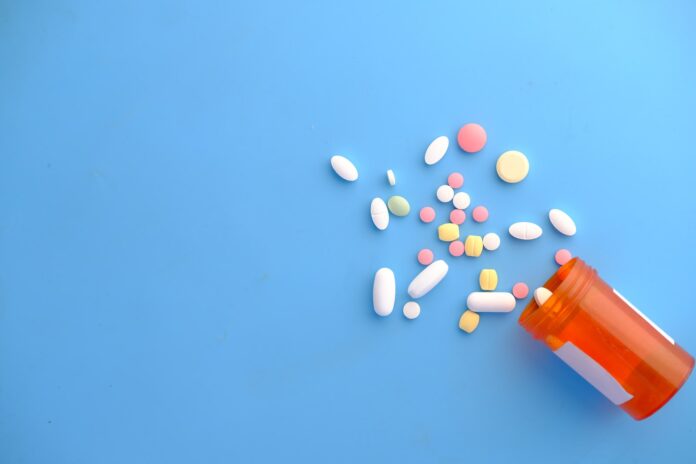 Photo by Towfiqu barbhuiya orange and white medication pill