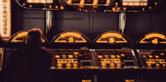 The Development Of Internet Gambling man playing arcade machine