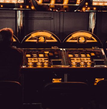 The Development Of Internet Gambling man playing arcade machine