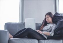 New Online Casinos woman sitting on sofa while using MacBook Pro