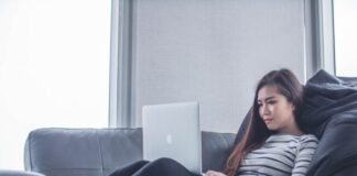 New Online Casinos woman sitting on sofa while using MacBook Pro