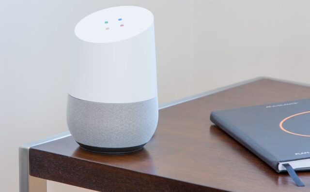 Photo by Thomas Kolnowski white and gray Google home on brown table