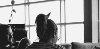 How to Find the Perfect Apartment Roommate grayscale photo of woman sitting on sofa