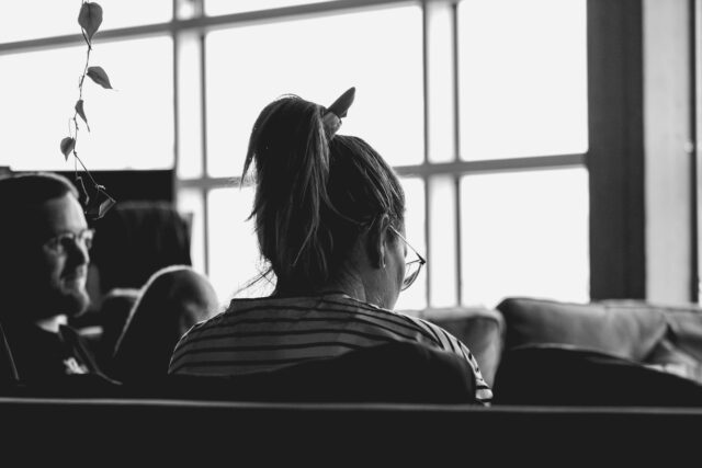Photo by Sigmund grayscale photo of woman sitting on sofa