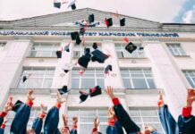 How to Apply for a College Scholarship group of fresh graduates students throwing their academic hat in the air