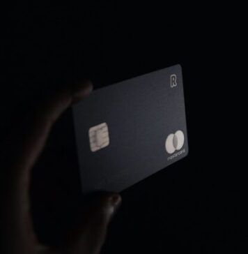 Factors that Affect the Cash Limit on Your Credit Card person holding black card