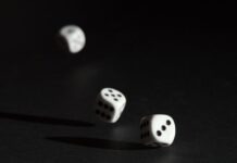 Online Casinos vs Live Casinos: Differences and Similarities 3 white dice on black surface