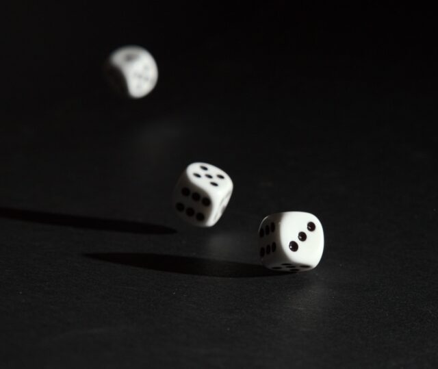 Photo by Alois Komenda 3 white dice on black surface