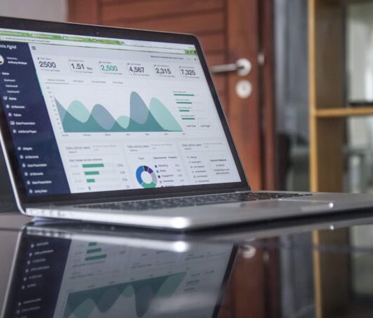 7 Ways Machine Learning and AI Can Improve Your Accounting laptop computer on glass-top table