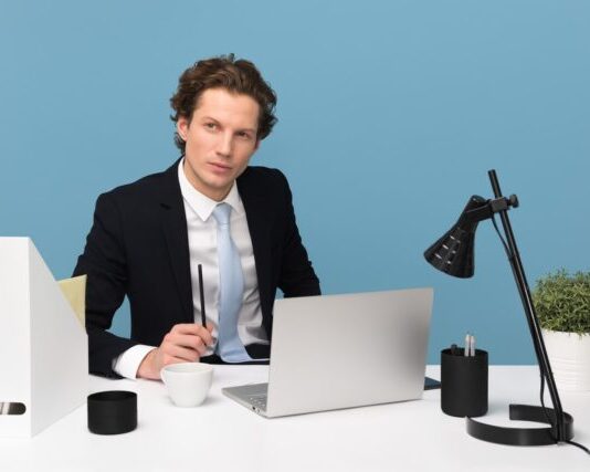 The 5 Steps to Making Your Business More Efficient man sitting on chair beside laptop computer and teacup