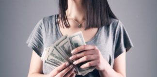 Top 10 Apps Like Big Cash to Play and Earn Money From Home woman in gray shirt holding fan of us dollar bills