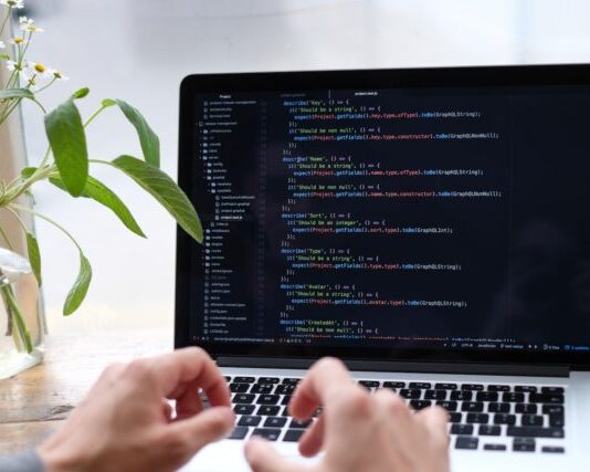 How to Build Your Own App person using macbook pro on white table