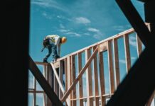 Reasons to Hire Construction Injury Attorneys in Chicago, Illinois man in yellow shirt and blue denim jeans jumping on brown wooden railings under blue and