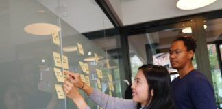 Understanding the Different Types of Roles in Product Management woman in gray sweater holding gold iphone 6