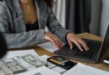 7 Ways to Cut Wasteful Spending in Your Business Budget A Woman in Plaid Blazer Using Her Laptop