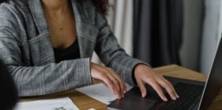 7 Ways to Cut Wasteful Spending in Your Business Budget A Woman in Plaid Blazer Using Her Laptop