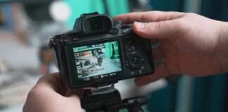 How to Create the Perfect Product Video in 2023 a person holding a camera up to take a picture