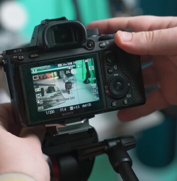 How to Create the Perfect Product Video in 2023 a person holding a camera up to take a picture