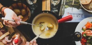 5 Ideas for an Unusual House Party two person holding fork dipping food on sauce