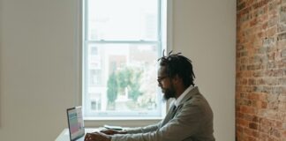 8 Lucrative Ways to Earn Money from Home: A Comprehensive Guide a person sitting at a desk with a laptop and papers