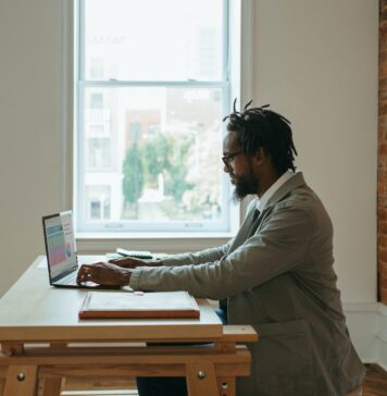 8 Lucrative Ways to Earn Money from Home: A Comprehensive Guide a person sitting at a desk with a laptop and papers