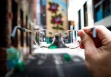 Pros and Cons of Getting Same-Day Prescription Glasses person holding eyeglasses