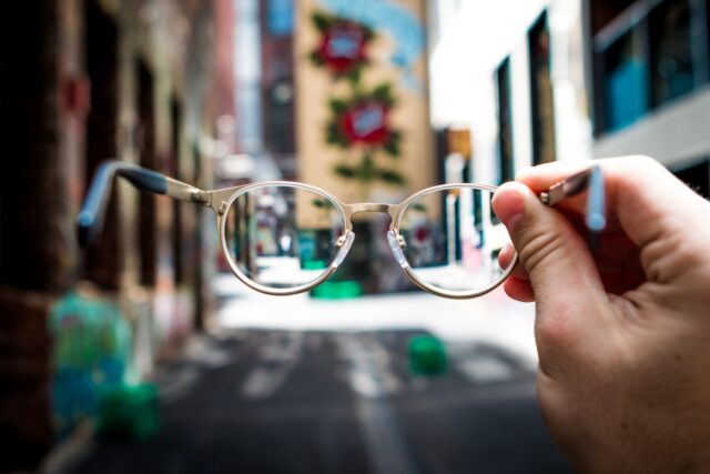 Photo by Josh Calabrese person holding eyeglasses