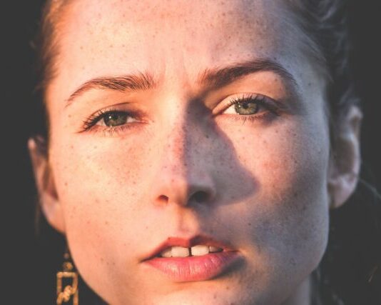 A Comprehensive Guide: How to Remove Wrinkles from Photos Easily sun rays of woman's face