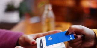 Simplify Your Invoicing Process with Zintego’s Free Invoice Generator, Invoice Templates, and Receipt Maker Software a person holding a credit card and a cell phone