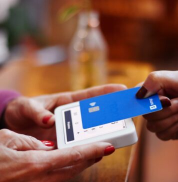 Simplify Your Invoicing Process with Zintego’s Free Invoice Generator, Invoice Templates, and Receipt Maker Software a person holding a credit card and a cell phone