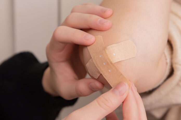 Photo by Diana Polekhina person holding band aid on left hand