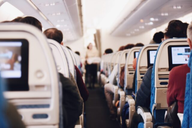 Photo by Suhyeon Choi shallow focus photography of people inside of passenger plane