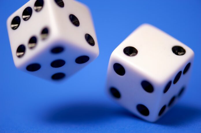 Photo by Edge2Edge Media 2 white dices on blue surface