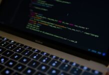 Maximize Sales: Why Python is a Game-Changer for E-commerce Website Development MacBook Pro with images of computer language codes
